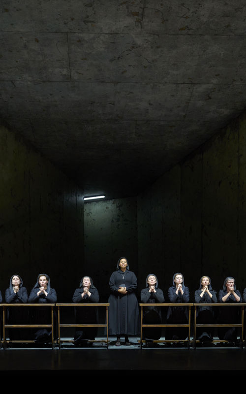 Praying nuns in a dark church